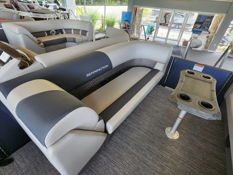 Slide: The Image of 2025 Bennington 22SSR pontoon boat interior with gray seating and cup holders. - 4