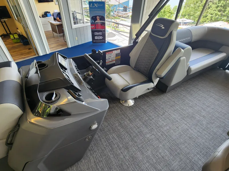 Slide: The Image of Interior of 2025 Bennington 22SSR pontoon boat with captain's chair and control console. - 6