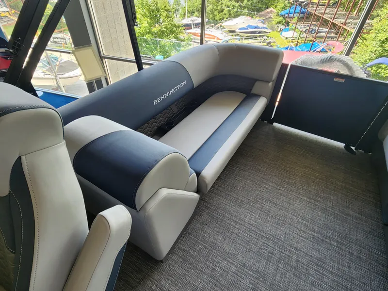 Slide: The Image of 2025 Bennington 22SSR pontoon boat interior with plush seating and modern design. - 9