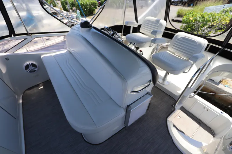 Slide: The Image of Interior of a 2007 Carver 35 Super Sport boat with white seating and helm chairs. - 17