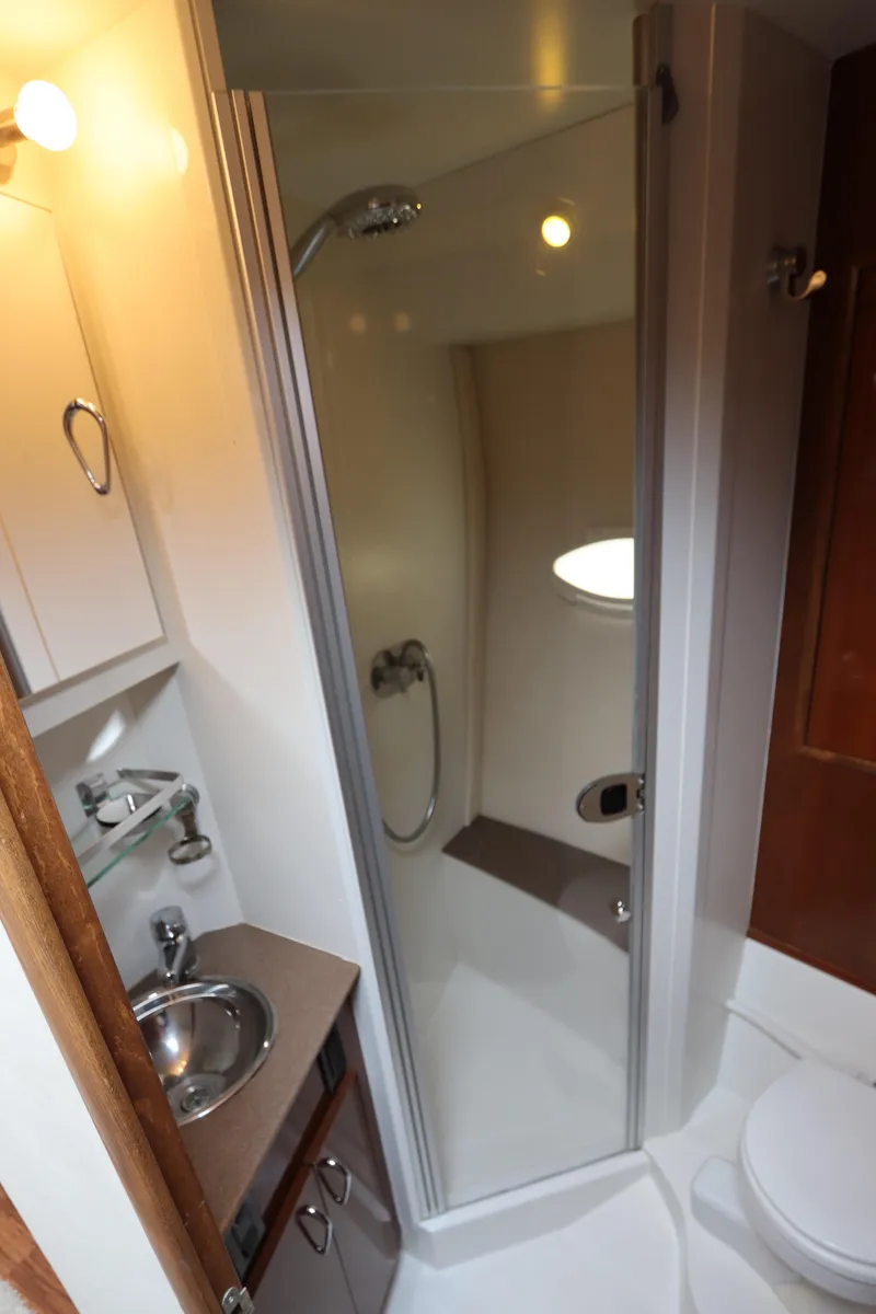 Slide: The Image of 2007 Carver 35 Super Sport bathroom with shower, sink, and toilet. - 36