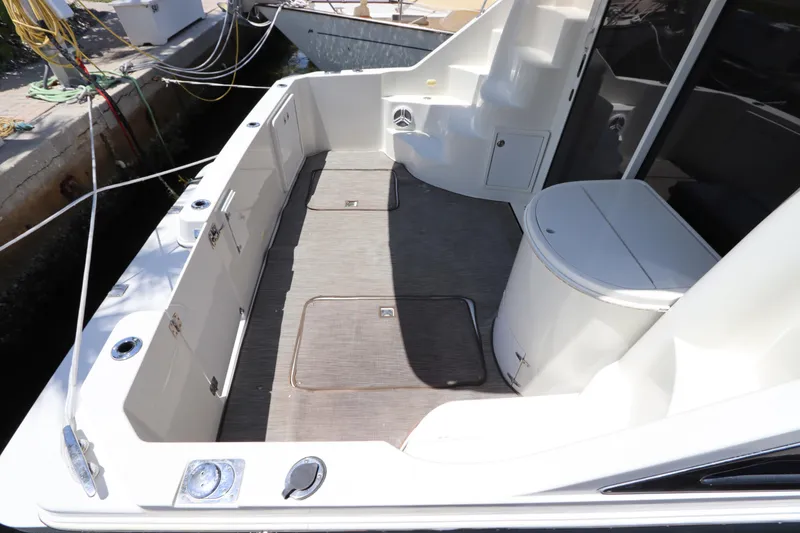 Slide: The Image of 2007 Carver 35 Super Sport boat deck with storage compartments and seating. - 6
