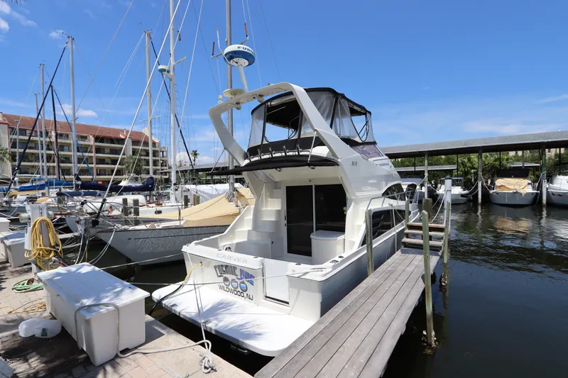 Slide: The Image of 2007 Carver 35 Super Sport yacht docked at a marina on a sunny day. - 2