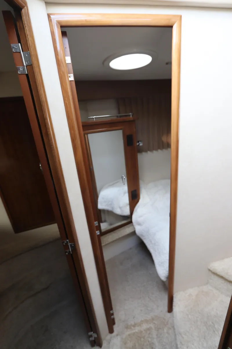 Slide: The Image of 2007 Carver 35 Super Sport cabin interior with bed and mirror. - 33