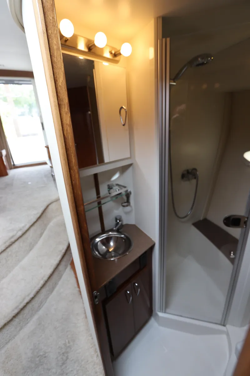 Slide: The Image of 2007 Carver 35 Super Sport yacht bathroom with shower, sink, and mirror. - 37
