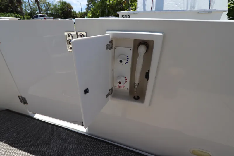 Slide: The Image of 2007 Carver 35 Super Sport boat with open storage compartment and shower controls. - 8