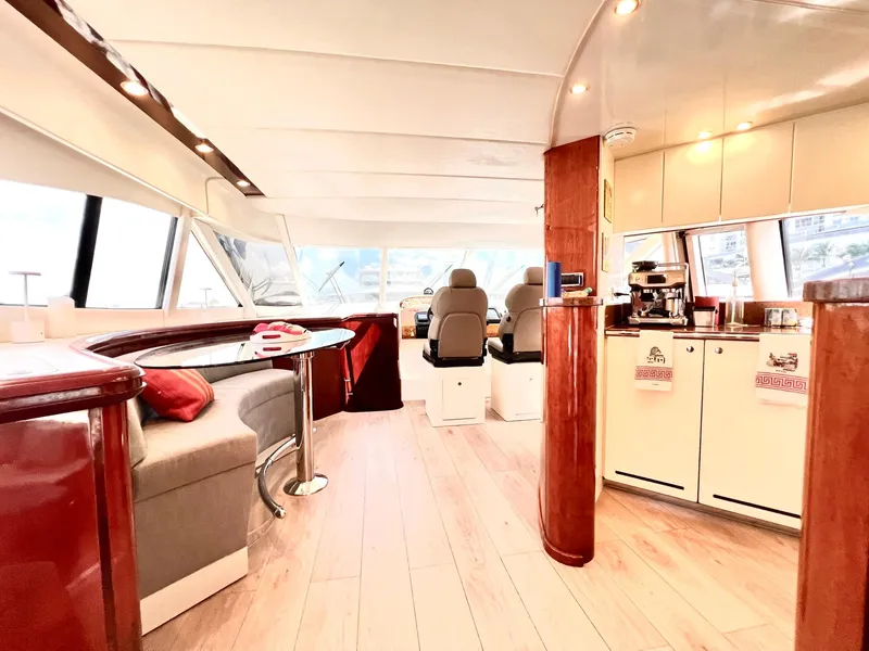 Slide: The Image of Luxurious interior of 1999 Fairline Squadron 65 yacht with modern seating and kitchen area. - 12