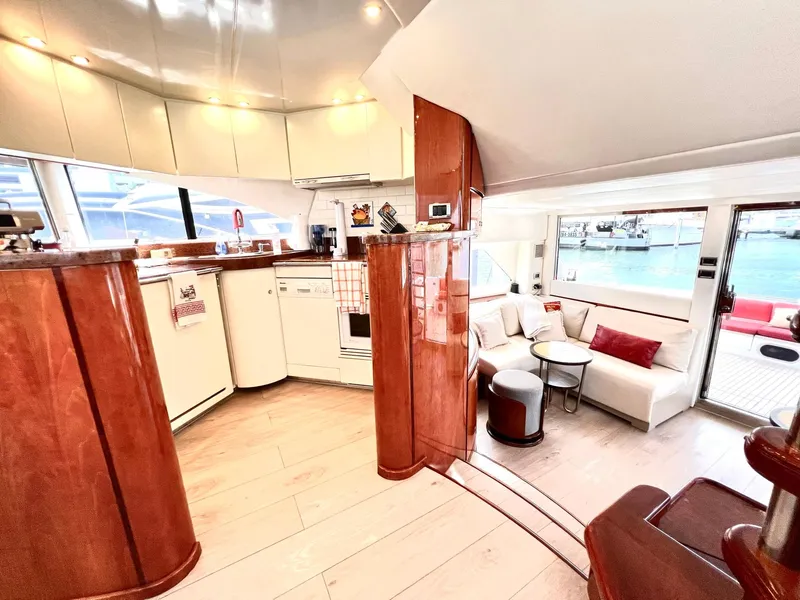 Slide: The Image of Luxurious interior of 1999 Fairline Squadron 65 yacht with modern kitchen and cozy seating area. - 13
