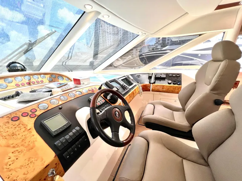 Slide: The Image of Luxurious helm of a 1999 Fairline Squadron 65 yacht with modern controls and plush seating. - 16
