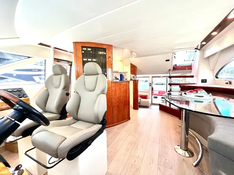 Slide: The Image of Interior of 1999 Fairline Squadron 65 yacht with modern seating and dining area. - 17