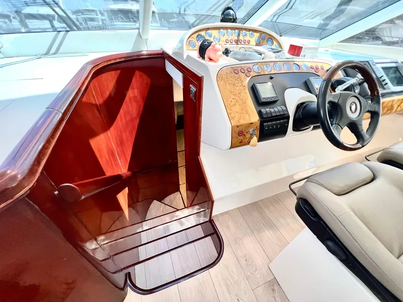 Slide: The Image of 1999 Fairline Squadron 65 yacht helm station with wooden stairs and modern controls. - 18