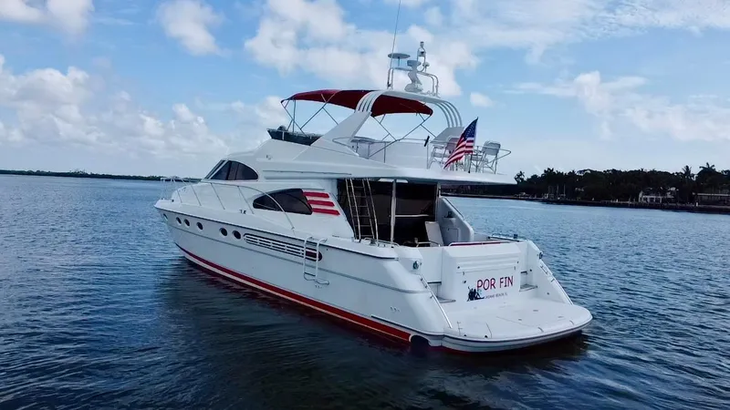 Slide: The Image of 1999 Fairline Squadron 65 yacht on calm waters with American flag. - 3