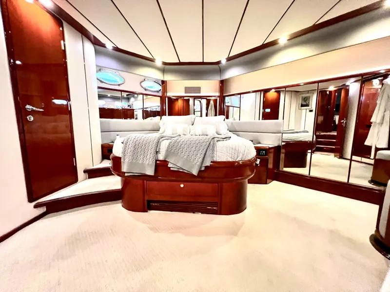 Slide: The Image of Luxurious master bedroom on a 1999 Fairline Squadron 65 yacht with elegant wood finishes. - 31