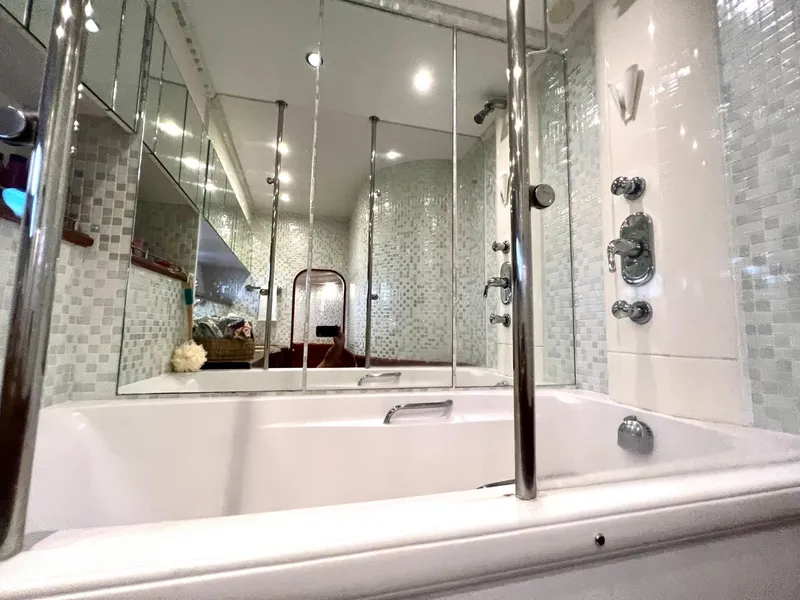 Slide: The Image of Luxurious bathroom in a 1999 Fairline Squadron 65 yacht with modern fixtures and mirrors. - 33