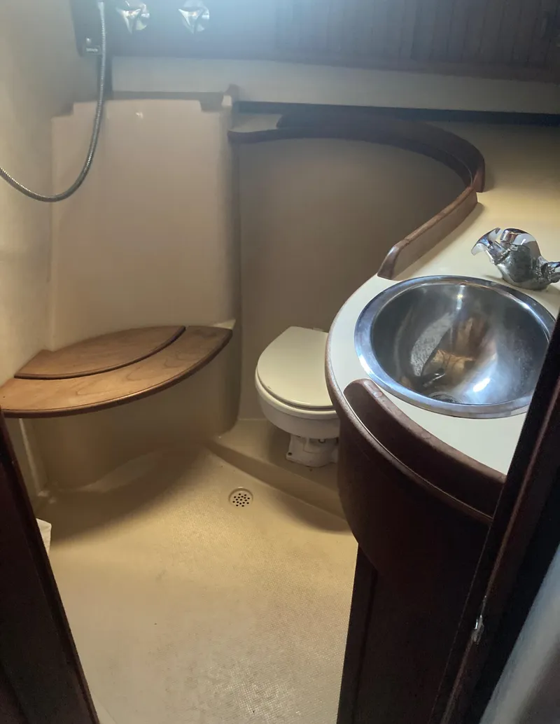 Slide: The Image of 1999 Island Packet 350 yacht bathroom with shower, toilet, and stainless steel sink. - 23