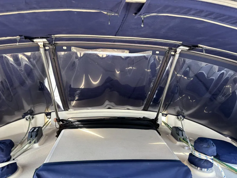 Slide: The Image of 1999 Island Packet 350 sailboat cockpit with blue canopy and ropes. - 9