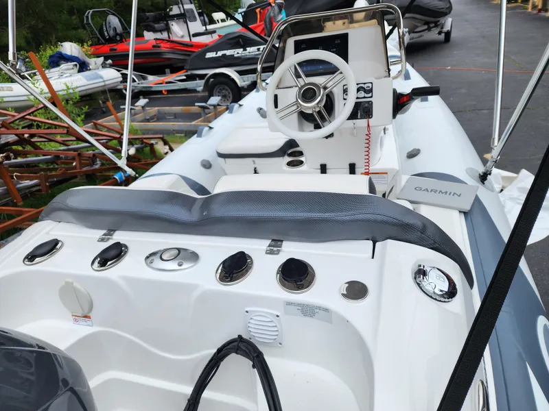 Slide: The Image of 2025 Walker Bay Venture 13 boat interior with steering wheel and control panel. - 4