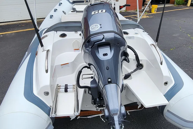 Slide: The Image of 2025 Walker Bay Venture 13 boat with 60 HP outboard motor, rear view. - 8