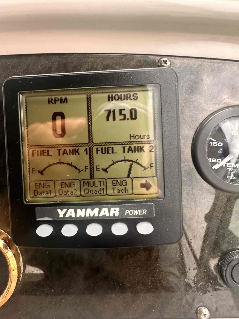 Slide: The Image of Yanmar power display on 2004 Cruisers Yachts 370 Express showing 715 engine hours. - 15