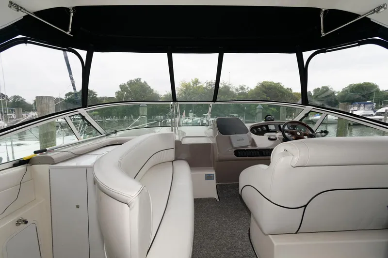 Slide: The Image of Interior of 2004 Cruisers Yachts 370 Express with white seating and helm station. - 3
