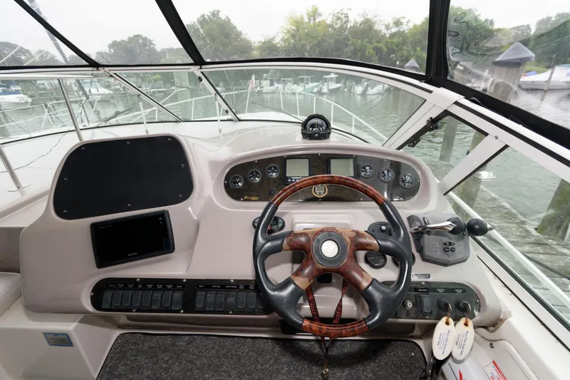 Slide: The Image of Helm of 2004 Cruisers Yachts 370 Express with steering wheel and control panel. - 5
