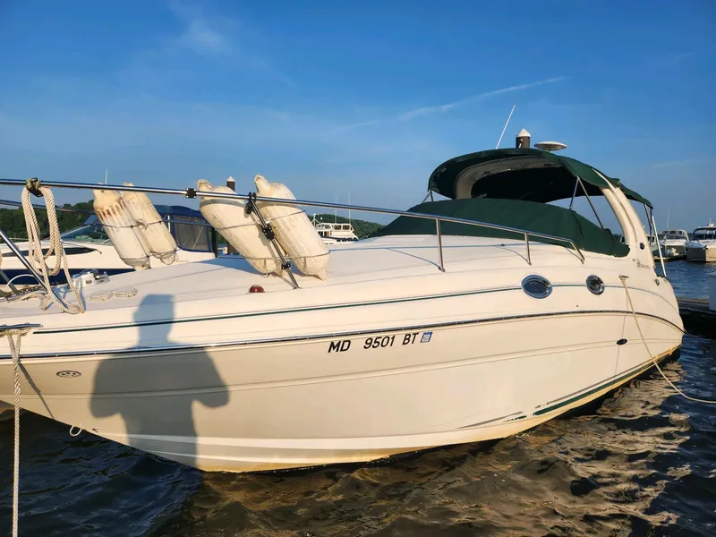 Slide: The Image of 2004 Sea Ray 280 Sundancer boat docked in a marina. - 0