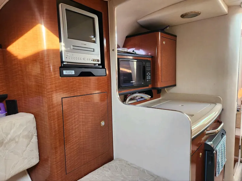 Slide: The Image of Interior of a 2004 Sea Ray 280 Sundancer with TV, microwave, and kitchenette. - 11