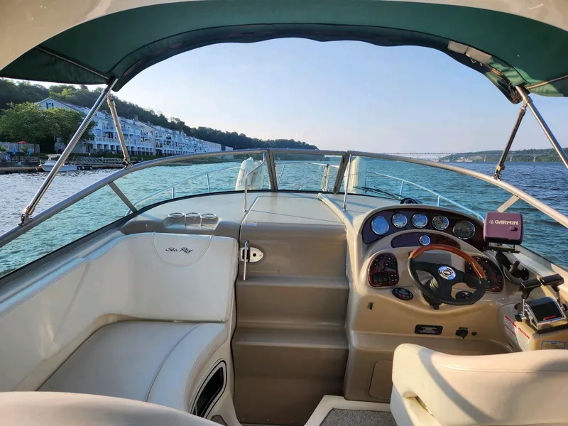 Slide: The Image of 2004 Sea Ray 280 Sundancer boat interior with scenic waterfront view. - 4