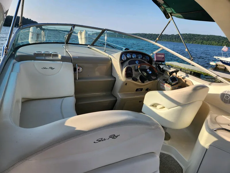 Slide: The Image of 2004 Sea Ray 280 Sundancer boat interior with steering console and seating. - 5
