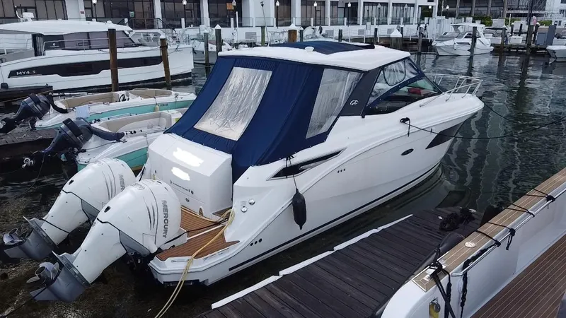 Slide: The Image of 2020 Sea Ray Sundancer 320 OB docked at marina with twin outboard engines. - 5