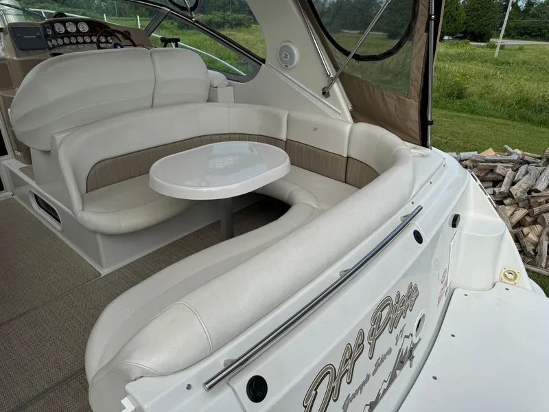 Slide: The Image of 2005 Four Winns 328 Vista boat interior with white seating and table. - 11