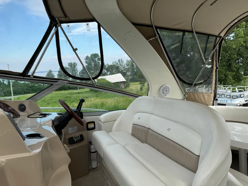 Slide: The Image of 2005 Four Winns 328 Vista boat interior with beige seating and panoramic windows. - 13