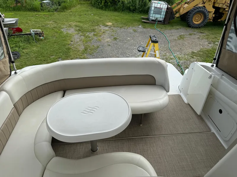 Slide: The Image of 2005 Four Winns 328 Vista boat interior with beige seating and table. - 16