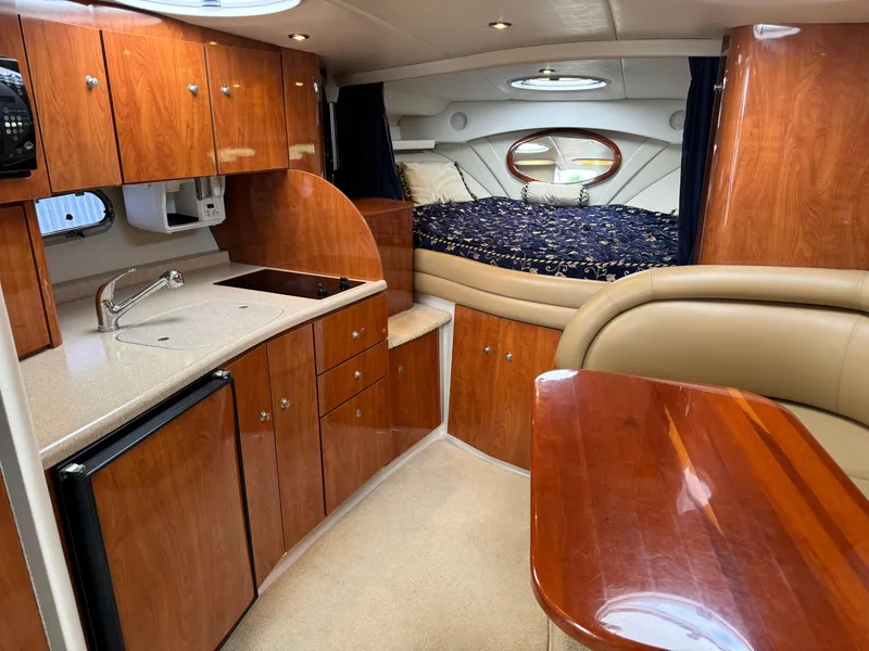 Slide: The Image of Interior of 2005 Four Winns 328 Vista boat with kitchen and cozy sleeping area. - 18