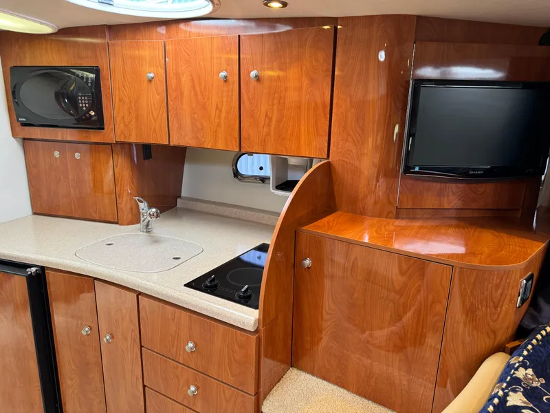 Slide: The Image of Luxurious 2005 Four Winns 328 Vista yacht interior with wood cabinetry and modern amenities. - 21