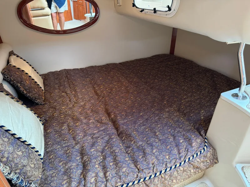 Slide: The Image of Cozy cabin interior of 2005 Four Winns 328 Vista with patterned bedding. - 24
