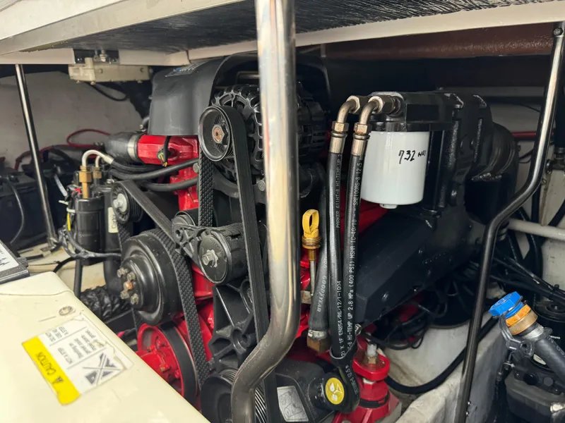 Slide: The Image of Engine compartment of a 2005 Four Winns 328 Vista boat, showcasing mechanical components. - 27