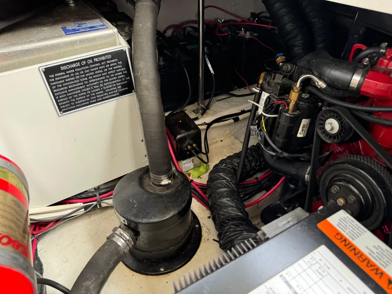 Slide: The Image of Engine compartment of 2005 Four Winns 328 Vista boat, showing mechanical components and wiring. - 29