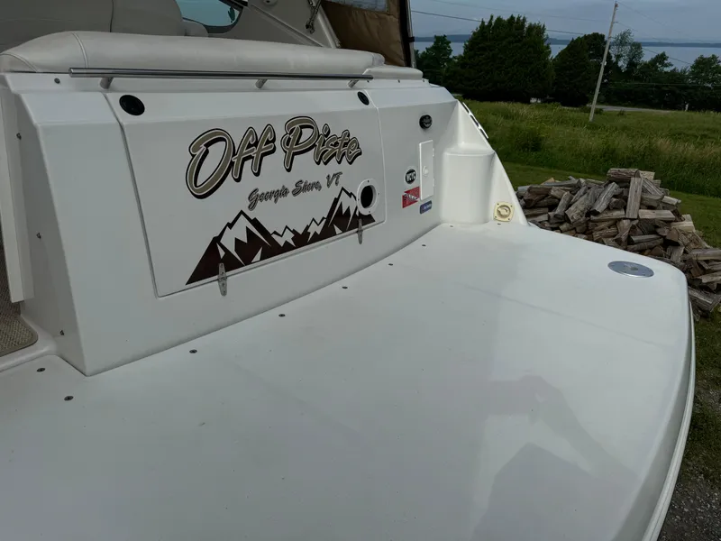 Slide: The Image of 2005 Four Winns 328 Vista boat with "Off Piste" decal, parked outdoors. - 7