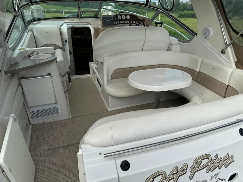 Slide: The Image of 2005 Four Winns 328 Vista boat interior with white seating and table. - 8