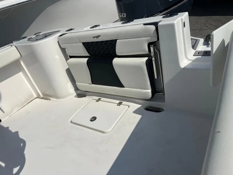 Slide: The Image of 2024 Tidewater 232 CC Adventure boat interior with foldable seating and storage compartment. - 5