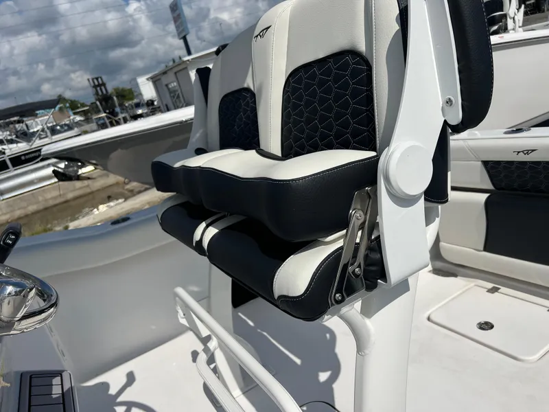 Slide: The Image of 2024 Tidewater 232 CC Adventure boat seating with black and white upholstery. - 6