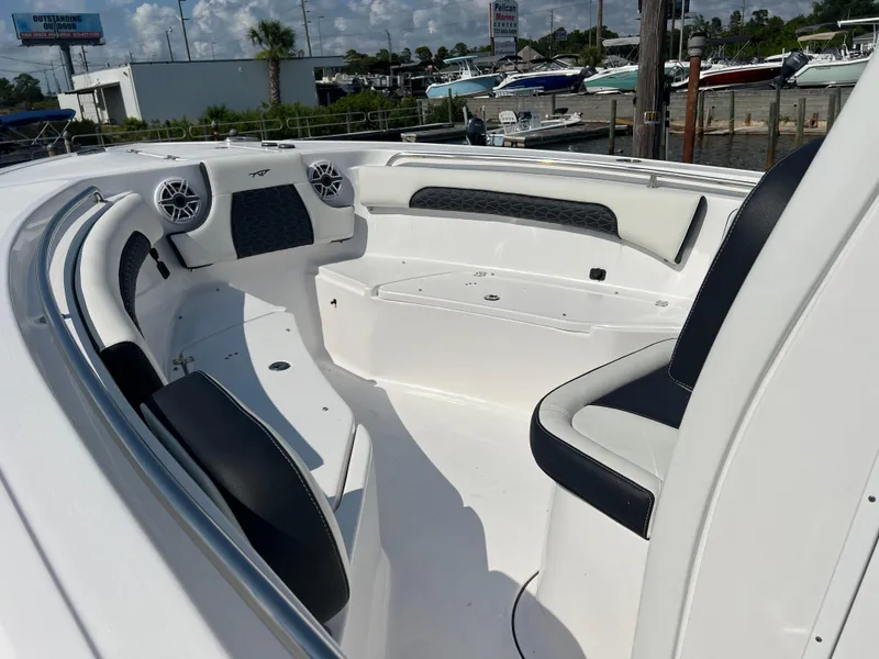 Slide: The Image of 2024 Tidewater 232 CC Adventure boat interior with seating and speakers. - 7