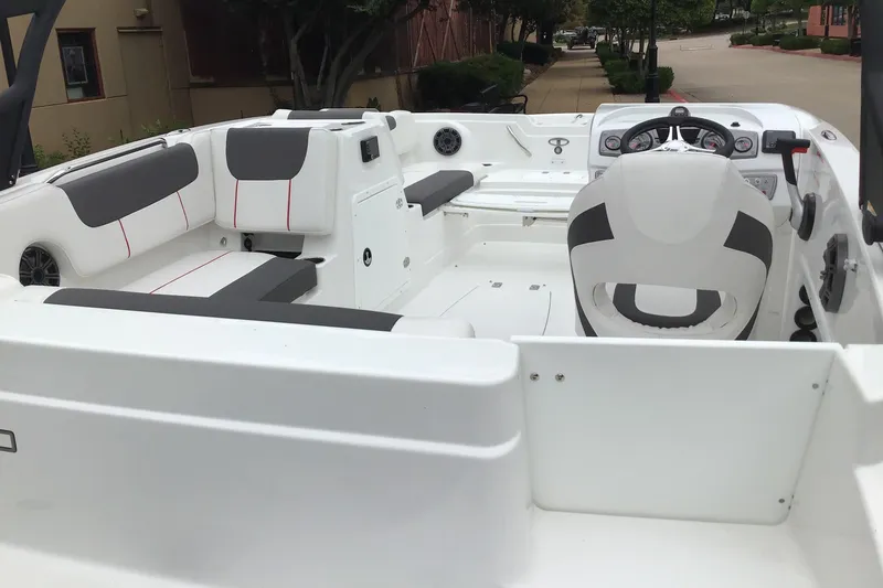 Slide: The Image of 2024 Tahoe 1950 boat interior with modern seating and steering console. - 2