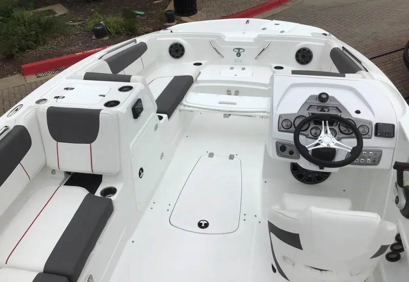 Slide: The Image of 2024 Tahoe 1950 boat interior with white and gray seating, modern dashboard, and spacious layout. - 3