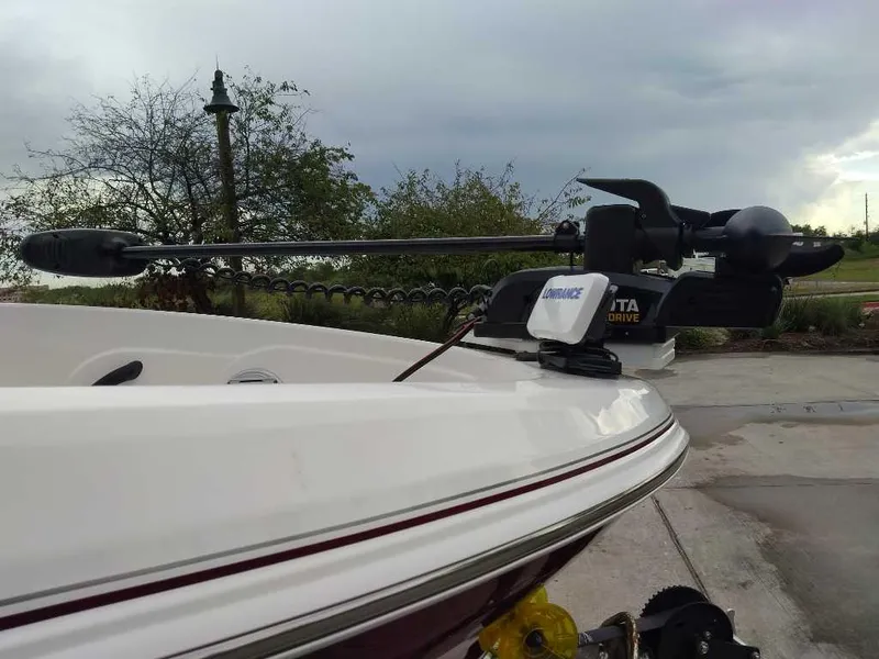 Slide: The Image of 2024 Tahoe 185 S boat with trolling motor on a cloudy day. - 2