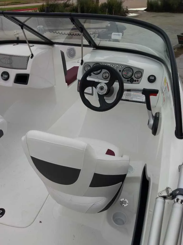 Slide: The Image of 2024 Tahoe 185 S boat interior with steering wheel and dashboard. - 3