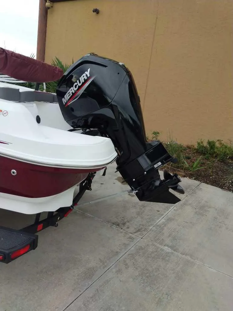 Slide: The Image of 2024 Tahoe 185 S boat with Mercury outboard motor on a trailer. - 4