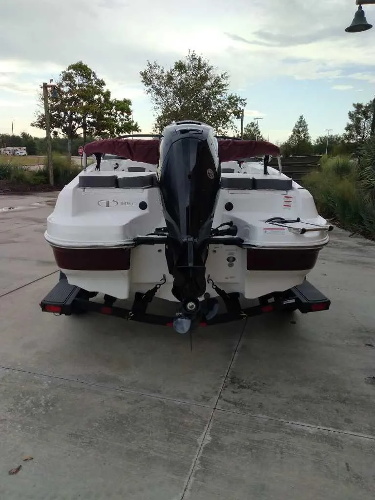 Slide: The Image of 2024 Tahoe 185 S boat, rear view, parked on concrete, outdoor setting. - 5