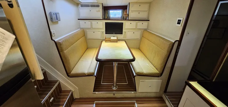 Slide: The Image of Interior of 1969 Derecktor 68 Hunt Motor Yacht with wicker furniture and nautical decor. - 12